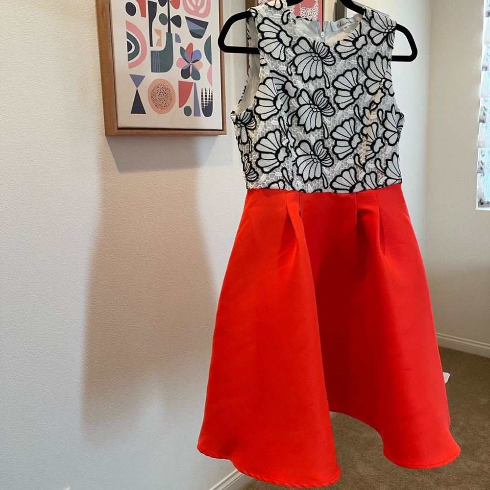 Cocktail bright orange dress with black and white lace details in Size Medium.